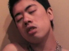 Cute Japanese guy gets naked on the beach big chest asian gay porn